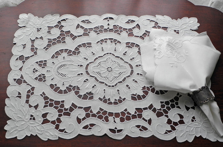 Hand-embroidered table linens featuring intricate designs, adding elegance and charm to any dining table