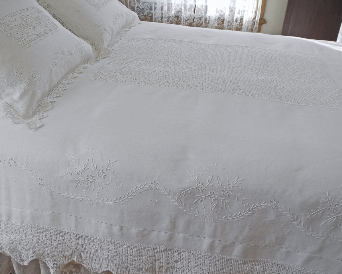 Hand embroidered bedcover in 100% linen. Finished with 8" hand crochet border and crochet center inset.