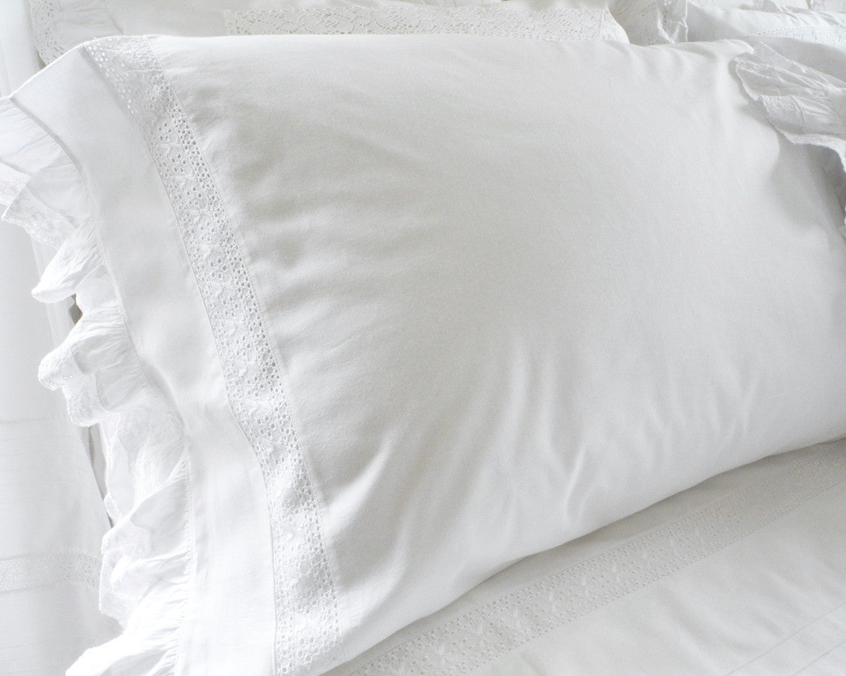 Cotton pillow case is decorated with lace inset and ruffle on the end.