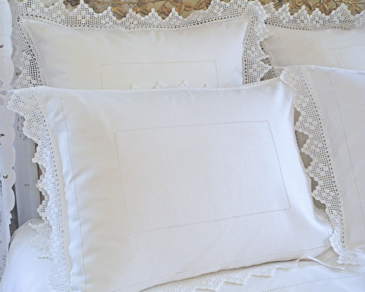 "French Country-style hand-embroidered linen sham with delicate hemstitch and crochet flange."
