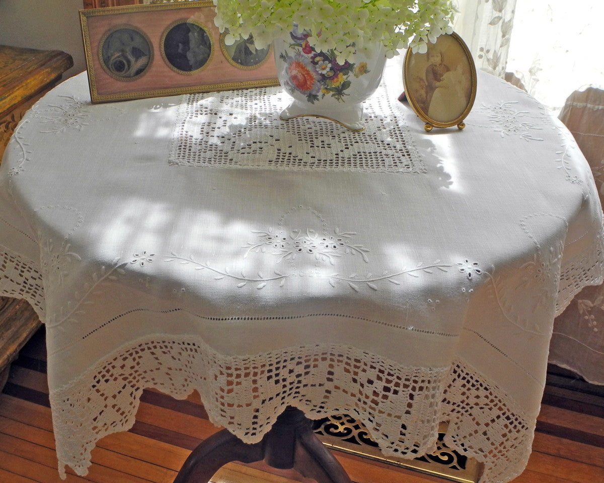 Linen table topper (36" square) hand embroidered and finished with crochet border and center inset.