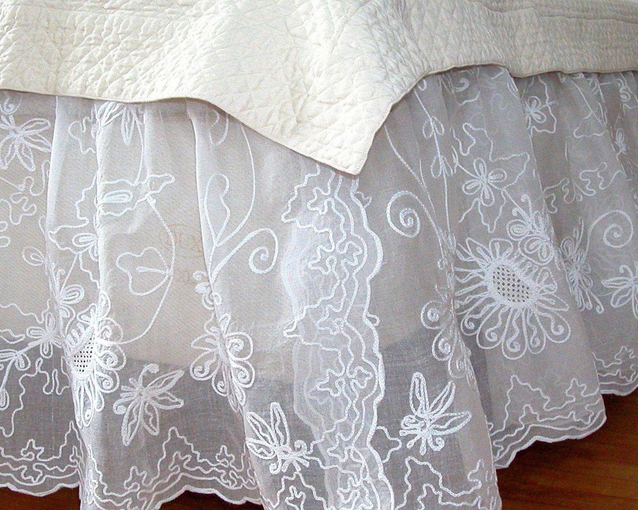 Charming dust skirt, embroidered with sunflower like pattern on 100% cotton organdy.