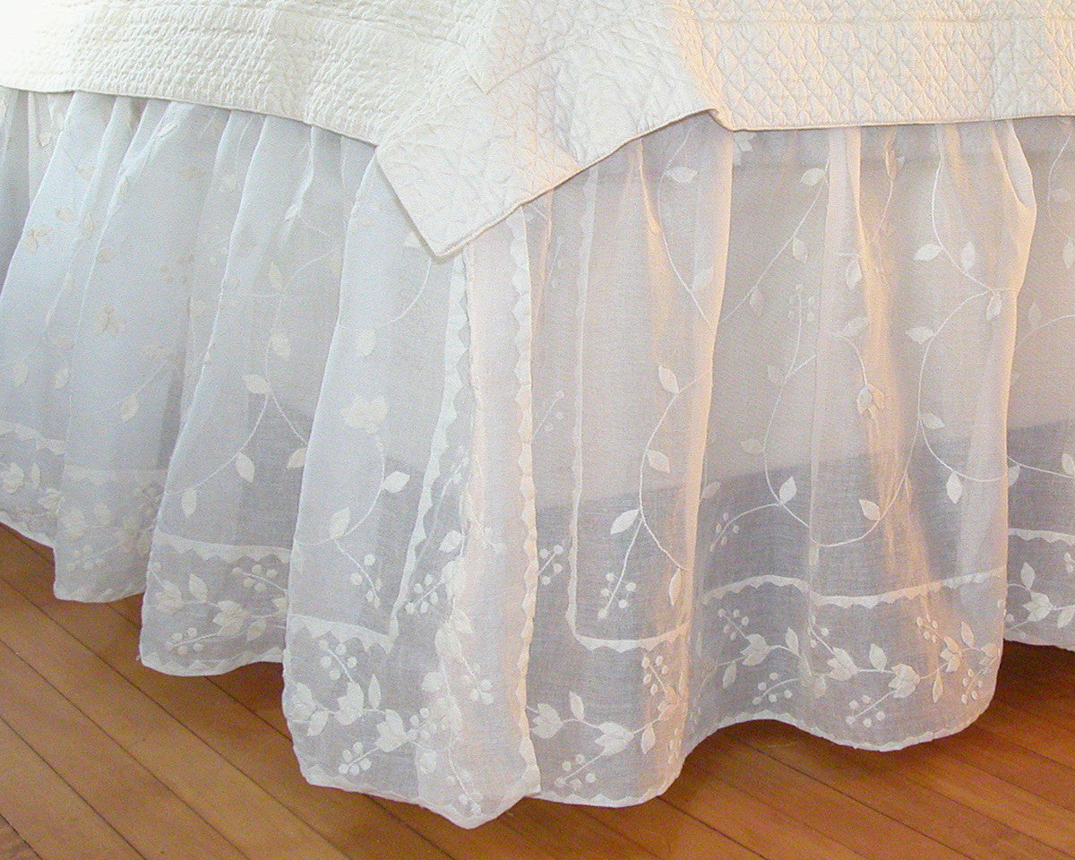 Dust skirt made of cotton organza and decorated with hand applique resembling grape leaves.