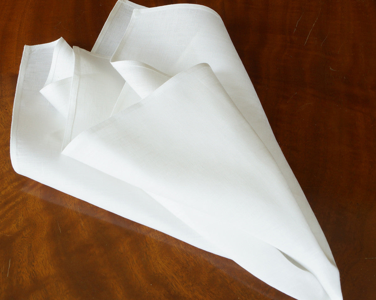 Oversize dinner napkin in pure white linen, finished with plain hem  border.