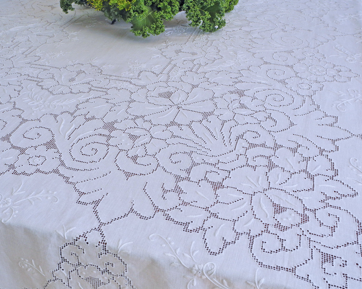 Close up detail of the fine execution of drawn work embroidery on this tablecloth.
