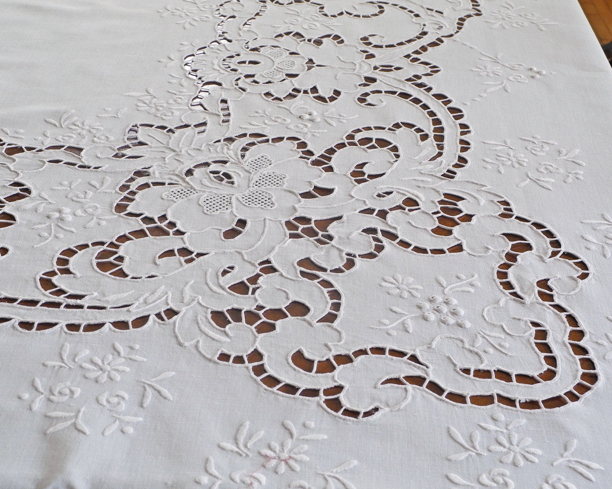 Close detail of cutwork embroidery, one of the styles used to embellish this tablecloth.