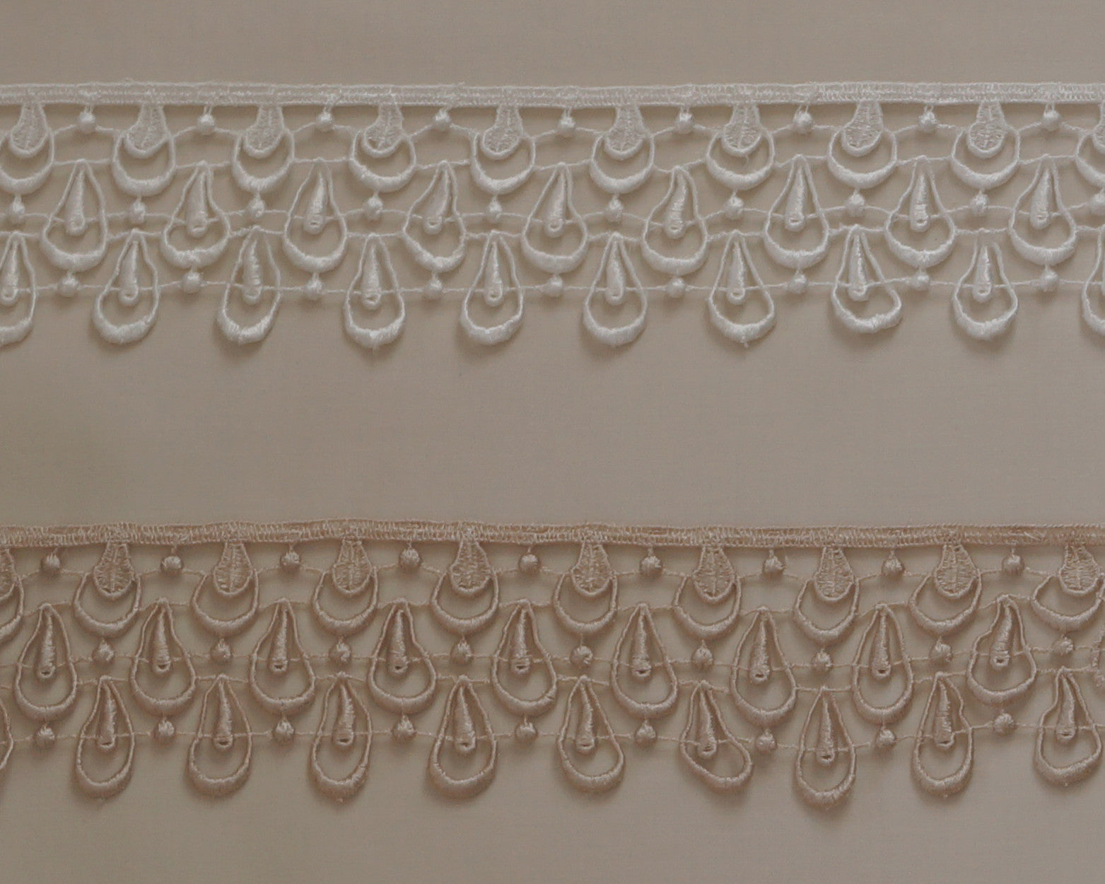 2 1/4" lace edging with tear drop like design in off white or taupe.
