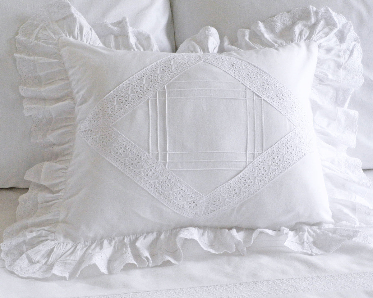 Boudoir pillow sham in white cotton decorated with vintage looking tucks and lace insets.
